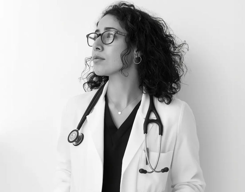 Classic black V-neck scrub top with single pocket paired with matching pants – minimalist and professional.