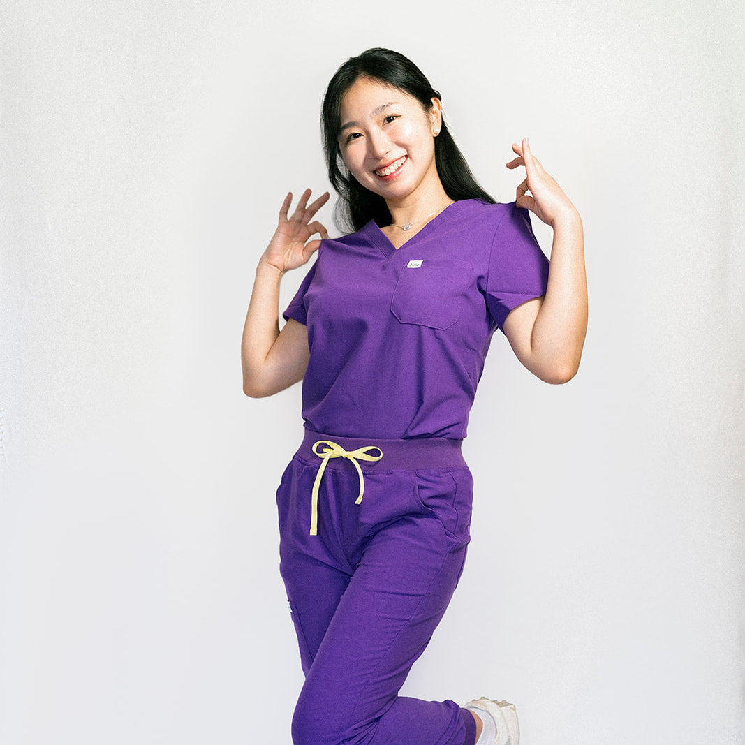 Person wearing a purple outfit with a white background